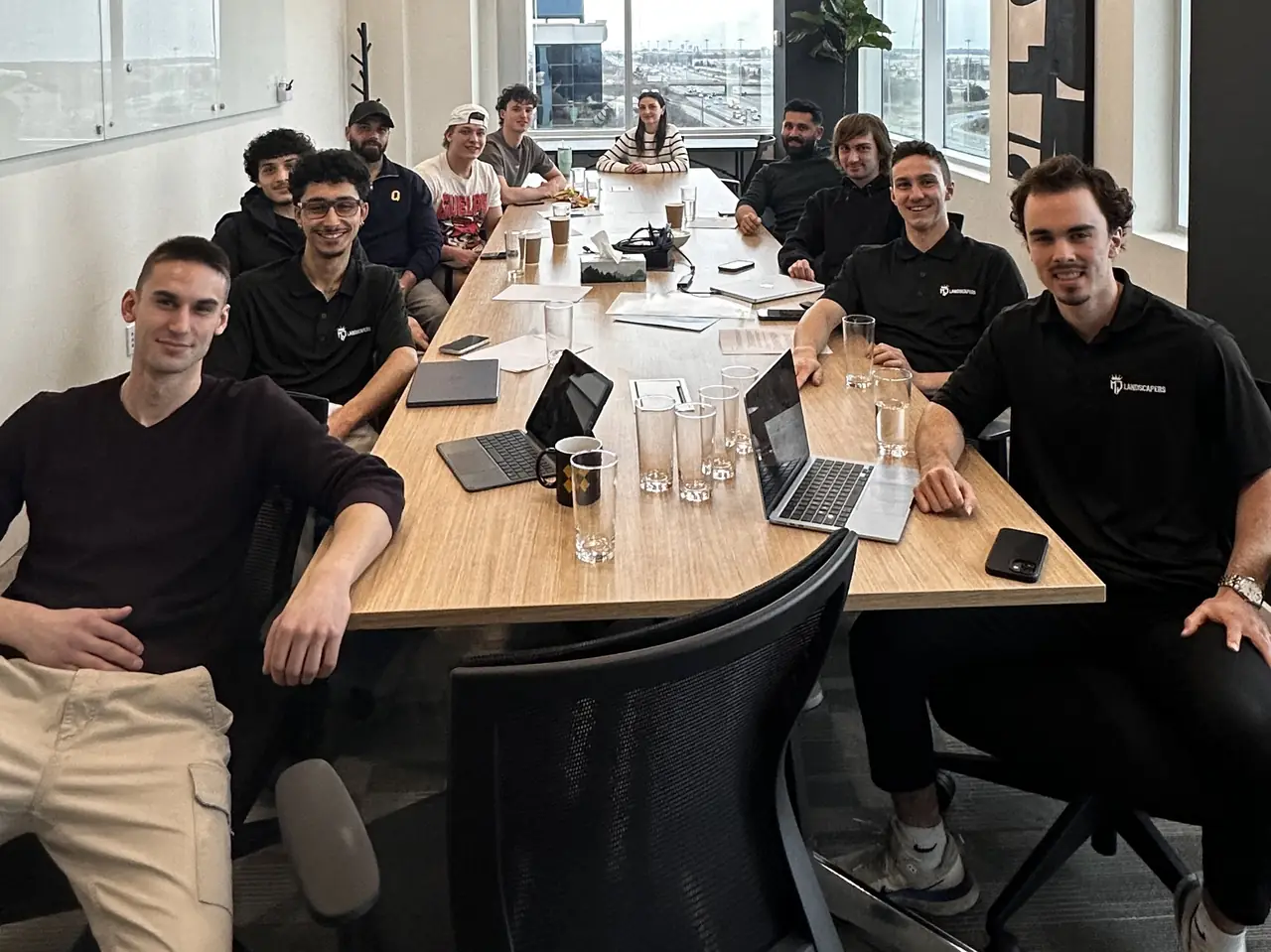 The MJ Landscapers team around a meeting table